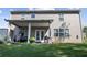 Home backyard featuring covered patio, green grass, and gray siding at 450 Noblewood Dr, Mcdonough, GA 30252