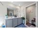 Bathroom featuring double sinks with gray cabinetry and decorative accents at 450 Noblewood Dr, Mcdonough, GA 30252