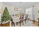 Cozy dining room with hardwood floors, chandelier, and large window providing natural light at 450 Noblewood Dr, Mcdonough, GA 30252