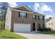 Attractive two-story brick home with a spacious two-car garage and well-maintained front yard at 450 Noblewood Dr, Mcdonough, GA 30252