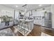 Modern kitchen with granite countertops, stainless steel appliances, and a stylish island with seating at 450 Noblewood Dr, Mcdonough, GA 30252