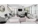 Comfortable living room with dark hardwood floors, fireplace, plush couches, and stairs to second floor at 450 Noblewood Dr, Mcdonough, GA 30252