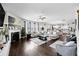 Open concept living room with hardwood floors, fireplace, plenty of seating, and open access to kitchen at 450 Noblewood Dr, Mcdonough, GA 30252