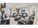 Cozy living room featuring plush black leather seating, glass coffee table, and modern decor at 450 Noblewood Dr, Mcdonough, GA 30252