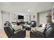 Comfortable living room features black leather couches and modern decor at 450 Noblewood Dr, Mcdonough, GA 30252