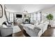 Bright living room boasts hardwood floors, fireplace, ceiling fan, and plush seating at 450 Noblewood Dr, Mcdonough, GA 30252