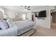 Spacious main bedroom featuring a ceiling fan, large tv, and walk-in closet at 450 Noblewood Dr, Mcdonough, GA 30252