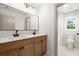 Bright bathroom with a double sink vanity, modern fixtures and a large mirror at 5125 Hyde Trl, Cumming, GA 30040