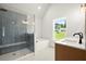 Modern bathroom featuring glass shower, soaker tub, and double sinks at 5125 Hyde Trl, Cumming, GA 30040