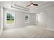 Large bedroom featuring tray ceiling and abundant natural light at 5125 Hyde Trl, Cumming, GA 30040