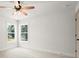 This bedroom is bright and open with big windows and neutral walls at 5125 Hyde Trl, Cumming, GA 30040