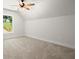 This bonus room has neutral carpet and trim with a big window overlooking the lawn at 5125 Hyde Trl, Cumming, GA 30040