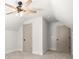 A bright bonus room with neutral carpet and a ceiling fan and two doors at 5125 Hyde Trl, Cumming, GA 30040
