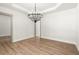 Bright dining room with modern chandelier and neutral color palette at 5125 Hyde Trl, Cumming, GA 30040