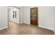 Bright entry room with a wooden door, large window and light wood floors at 5125 Hyde Trl, Cumming, GA 30040