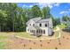 Back exterior view with modern home featuring a covered patio and a large yard at 5125 Hyde Trl, Cumming, GA 30040