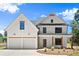 Charming two-story home featuring a symmetrical facade, two-car garage, and inviting front porch at 5125 Hyde Trl, Cumming, GA 30040