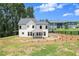 A back exterior view of the house with a covered patio overlooking a grassy yard at 5125 Hyde Trl, Cumming, GA 30040