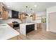 Open kitchen with wooden cabinets, stainless steel appliances, and white countertop island at 5125 Hyde Trl, Cumming, GA 30040