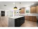 Bright, open-concept kitchen features a large island, stainless appliances, and ample cabinetry at 5125 Hyde Trl, Cumming, GA 30040