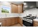 Charming kitchen showcasing stainless steel appliances, white tile backsplash, and ample cabinet space at 5125 Hyde Trl, Cumming, GA 30040