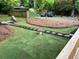 Spacious backyard with a well-maintained lawn, custom stone pathway, and mature trees at 944 Woodland Ave, Atlanta, GA 30316