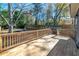 Backyard featuring a wooden deck and landscaped yard with a stone pathway and privacy fence at 944 Woodland Ave, Atlanta, GA 30316