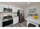 Modern kitchen featuring stainless steel appliances, granite countertops and white cabinetry at 944 Woodland Ave, Atlanta, GA 30316
