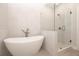 A stylish bathroom features a modern soaking tub, a glass-enclosed shower, and tiled walls and flooring at 280 Briscoe Way # 38, Alpharetta, GA 30009