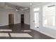 Large bedroom with hardwood floors, tray ceiling, and multiple doorways at 280 Briscoe Way # 38, Alpharetta, GA 30009
