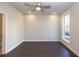 Bright, unfurnished bedroom with dark hardwood floors, neutral paint, a ceiling fan and a window for natural light at 280 Briscoe Way # 38, Alpharetta, GA 30009