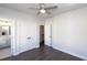 The bedroom has hardwood floors, a ceiling fan, double closets, and a view into an adjacent bathroom at 280 Briscoe Way # 38, Alpharetta, GA 30009