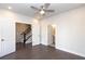Bedroom with dark hardwood floors, neutral paint, ceiling fan and two doorways; one to bathroom and one to hall at 280 Briscoe Way # 38, Alpharetta, GA 30009