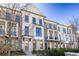 Charming brick townhomes with inviting balconies and classic architectural details, all set against a clear blue sky at 280 Briscoe Way # 38, Alpharetta, GA 30009