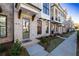 Inviting brick townhome entrance featuring a stylish green door, manicured landscaping, and a welcoming pathway at 280 Briscoe Way # 38, Alpharetta, GA 30009