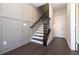 Hallway features elegant dark hardwood floors, a staircase, and wainscotting on the left for added architectural detail at 280 Briscoe Way # 38, Alpharetta, GA 30009