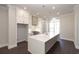 Bright kitchen features a large quartz island, stainless steel appliances, and custom white cabinetry at 280 Briscoe Way # 38, Alpharetta, GA 30009