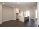 Open kitchen with quartz island, stainless steel appliances, white cabinets, recessed lights and hardwood floors at 280 Briscoe Way # 38, Alpharetta, GA 30009