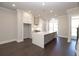 Bright kitchen features a large quartz island, stainless steel appliances, and custom white cabinetry at 280 Briscoe Way # 38, Alpharetta, GA 30009