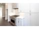 Kitchen featuring stainless steel appliances and white cabinets with stone backsplash at 280 Briscoe Way # 38, Alpharetta, GA 30009