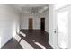 A spacious living room features a tray ceiling, ceiling fan, hardwood floors, and a view of an open hallway at 280 Briscoe Way # 38, Alpharetta, GA 30009