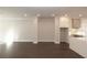 Open-concept living space featuring dark hardwood floors, recessed lighting, and a modern kitchen with an island at 280 Briscoe Way # 38, Alpharetta, GA 30009