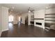 Open concept living space with fireplace, floating shelves, and dark hardwood flooring at 280 Briscoe Way # 38, Alpharetta, GA 30009