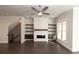 Bright living room features a fireplace, built-in shelves, and dark hardwood flooring at 280 Briscoe Way # 38, Alpharetta, GA 30009