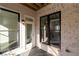 A brick patio features a black framed window and exterior door at 280 Briscoe Way # 38, Alpharetta, GA 30009