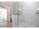 This bright shower features a glass enclosure, white tile, and a view into the main bathroom at 280 Briscoe Way # 38, Alpharetta, GA 30009