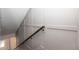Bright, spacious staircase features a dark wooden railing and white wainscoting that lead to the home's upper level at 280 Briscoe Way # 38, Alpharetta, GA 30009
