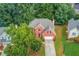 Aerial view of a two-story brick home featuring a well-maintained lawn and mature trees at 1446 Chadwick Ridge Ct, Lawrenceville, GA 30043