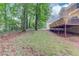 A grassy backyard with mature trees and deck access at 1446 Chadwick Ridge Ct, Lawrenceville, GA 30043