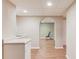 Finished basement area with wood-look flooring, utility sink and arched doorway to the exercise area at 1446 Chadwick Ridge Ct, Lawrenceville, GA 30043